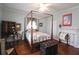 Bright bedroom with a four poster bed, ceiling fan, hardwood floors, and a decorative non-working fireplace at 30 Sessions Nw St, Marietta, GA 30060