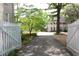 Long driveway leading to a beautiful home, framed by a white fence and mature trees at 30 Sessions Nw St, Marietta, GA 30060