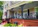 Lovely home with a charming front porch, adorned with black iron railings, ceiling fan and wicker furniture at 30 Sessions Nw St, Marietta, GA 30060