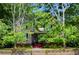 Elegant two-story home with a charming front porch, surrounded by mature trees and a green lawn at 30 Sessions Nw St, Marietta, GA 30060