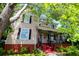 Beautiful two-story house featuring classic architecture and a welcoming front porch with the American flag at 30 Sessions Nw St, Marietta, GA 30060