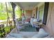 Inviting front porch featuring wicker furniture, ceiling fan and a swing for relaxing on a beautiful afternoon at 30 Sessions Nw St, Marietta, GA 30060