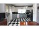 Kitchen features checkered floors, white cabinets, and modern appliances at 30 Sessions Nw St, Marietta, GA 30060
