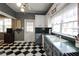 Traditional-style kitchen featuring black and white floors, green counters, a view to the sunroom, and white upper cabinets at 30 Sessions Nw St, Marietta, GA 30060