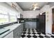 Traditional kitchen with black and white diamond pattern floors, gray lower cabinets, and black refrigerator at 30 Sessions Nw St, Marietta, GA 30060