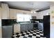 Bright kitchen with checkered floors, updated appliances, and ample counter space at 30 Sessions Nw St, Marietta, GA 30060
