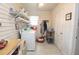 Functional laundry room with white appliances, ample storage shelves, and tile flooring at 30 Sessions Nw St, Marietta, GA 30060