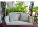 Cozy porch with a comfortable white wicker swing featuring patterned pillows at 30 Sessions Nw St, Marietta, GA 30060