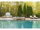 Beautiful in-ground swimming pool and hot tub, complemented by outdoor furniture and trees for shade and privacy at 3380 Hill Forest Nw Trl, Acworth, GA 30101