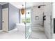 Bright bathroom featuring a freestanding tub, glass shower, and hanging chandelier light at 3380 Hill Forest Nw Trl, Acworth, GA 30101