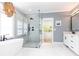 Bright bathroom with marble floors, soaking tub, seamless glass shower, and modern fixtures at 3380 Hill Forest Nw Trl, Acworth, GA 30101
