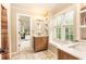 Bright bathroom with dual vanities, tiled floor, and a window view at 3380 Hill Forest Nw Trl, Acworth, GA 30101