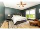 Comfortable bedroom with a ceiling fan, natural light, hardwood floors, and a chair at 3380 Hill Forest Nw Trl, Acworth, GA 30101