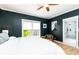 Comfortable bedroom with a chair, natural light, hardwood floors and ensuite bathroom at 3380 Hill Forest Nw Trl, Acworth, GA 30101