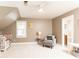 Serene bedroom with a crib, armchair, and window, creating a cozy atmosphere at 3380 Hill Forest Nw Trl, Acworth, GA 30101