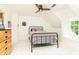 Cozy bedroom with a metal bed frame, ceiling fan, and a sunny window nook at 3380 Hill Forest Nw Trl, Acworth, GA 30101