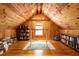 Cozy bonus room with wood-paneled walls, ceilings, and floors, featuring a desk and shelving for books at 3380 Hill Forest Nw Trl, Acworth, GA 30101