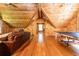A bonus room with wood-paneled walls and ceilings and flooring, features a sitting area and table tennis game at 3380 Hill Forest Nw Trl, Acworth, GA 30101