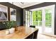 Inviting dining room with wood table, dark accent wall, and french doors to deck at 3380 Hill Forest Nw Trl, Acworth, GA 30101