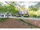 Beautiful house exterior showcasing curb appeal, landscaping, and a long driveway at 3380 Hill Forest Nw Trl, Acworth, GA 30101