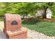 Charming white farmhouse with a welcoming front porch, seen behind a brick mailbox and landscaped yard at 3380 Hill Forest Nw Trl, Acworth, GA 30101