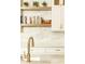 Bright kitchen features white cabinets, marble countertops, and brass hardware at 3380 Hill Forest Nw Trl, Acworth, GA 30101