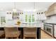 Modern kitchen featuring a large island with seating, pendant lighting, and marble countertops at 3380 Hill Forest Nw Trl, Acworth, GA 30101
