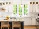 Well-lit kitchen featuring marble countertops, pendant lights, and modern cabinetry at 3380 Hill Forest Nw Trl, Acworth, GA 30101