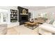 Sunlit living room featuring a black fireplace, built-in shelving, and modern furnishings at 3380 Hill Forest Nw Trl, Acworth, GA 30101
