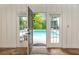 Inviting pool viewed through French doors, providing a seamless transition to outdoor relaxation at 3380 Hill Forest Nw Trl, Acworth, GA 30101