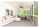 Inviting screened porch with comfortable seating, ceiling fans, and views of the surrounding greenery at 3380 Hill Forest Nw Trl, Acworth, GA 30101