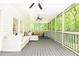 Relaxing screened porch with ample seating, striped rug, and a peaceful outdoor view at 3380 Hill Forest Nw Trl, Acworth, GA 30101