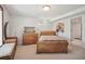 Neutral basement bedroom, wood furnishings, and a small window with a view at 8145 Stone Hill Rd, Cumming, GA 30028