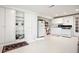 Basement kitchen with white cabinets, vintage appliances, and walkout access to yard at 8145 Stone Hill Rd, Cumming, GA 30028