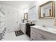 Bright bathroom with double sink vanity and white tile flooring at 8145 Stone Hill Rd, Cumming, GA 30028