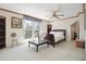Bright bedroom boasts a ceiling fan, furniture, and large window with lovely natural view at 8145 Stone Hill Rd, Cumming, GA 30028