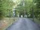 Gated driveway leading up to a wooded home at 8145 Stone Hill Rd, Cumming, GA 30028
