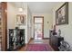 Inviting entryway with a decorative cabinet, artwork, and a view to the outside at 8145 Stone Hill Rd, Cumming, GA 30028