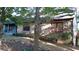 Charming stone house with red-trimmed windows is nestled in a serene, wooded landscape with a landscaped front yard at 8145 Stone Hill Rd, Cumming, GA 30028