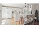 Spacious white kitchen features an island cooktop, breakfast bar, and modern appliances at 8145 Stone Hill Rd, Cumming, GA 30028
