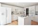 Well-lit kitchen boasts white cabinetry, stainless appliances and island with cooktop at 8145 Stone Hill Rd, Cumming, GA 30028