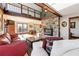 Inviting living room with stone fireplace, wooden beams and loft at 8145 Stone Hill Rd, Cumming, GA 30028
