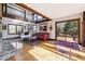 Bright living room boasts hardwood floors, stone fireplace, and access to a private deck at 8145 Stone Hill Rd, Cumming, GA 30028