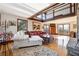 Open-concept living room features a stone fireplace, hardwood floors, and lots of natural light at 8145 Stone Hill Rd, Cumming, GA 30028