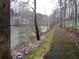 Scenic pathway beside a tranquil lake surrounded by bare trees and a dusting of snow at 8145 Stone Hill Rd, Cumming, GA 30028