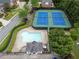 Aerial view of community amenities: pool, pool house, and two tennis courts at 1273 Promontory Ln, Marietta, GA 30062