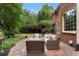 Brick home offers a lovely patio and backyard surrounded by lush greenery, providing a private outdoor retreat at 1273 Promontory Ln, Marietta, GA 30062