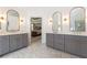 Primary bathroom with dual sinks, white countertops, gray cabinetry, and doorway to bedroom at 1273 Promontory Ln, Marietta, GA 30062