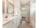 Bright, clean bathroom featuring a double vanity and a doorway leading to a bedroom at 1273 Promontory Ln, Marietta, GA 30062