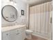 Classic bathroom with a vanity, a round mirror, and a bathtub with shower at 1273 Promontory Ln, Marietta, GA 30062